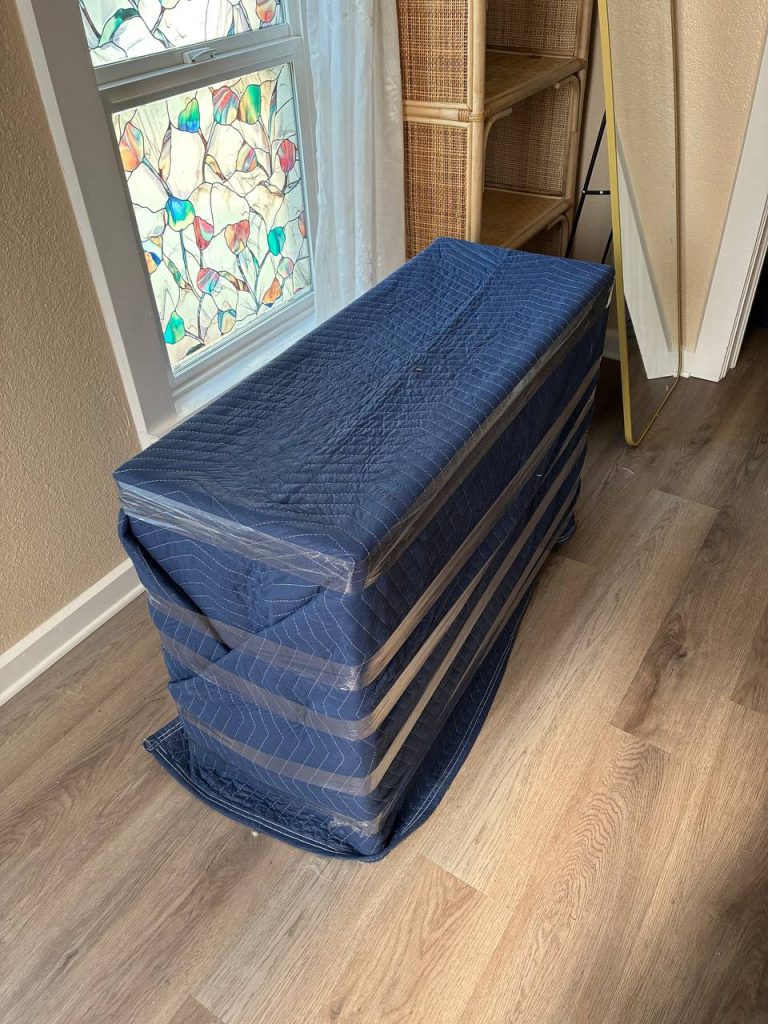 Professional movers lifting heavy furniture in Aurora with PackPalTeam