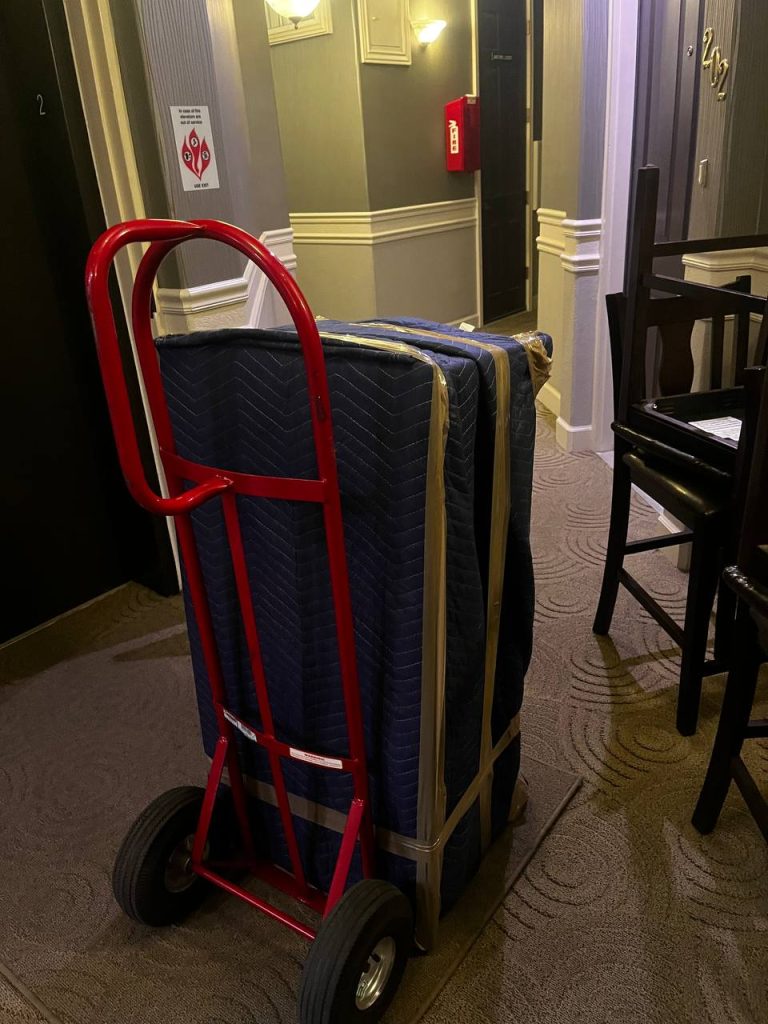 Professional pool table installers near me reassembling and precisely leveling a billiard table after move in Boulder, Colorado.